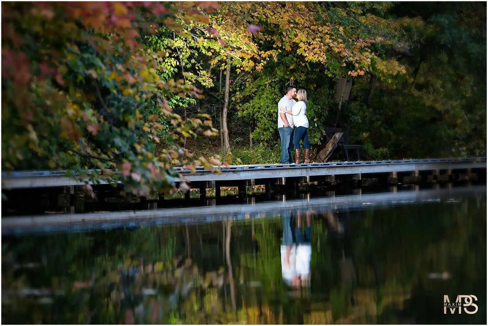 a man and woman standing on a dock by a lake at Cincinnati Nature Center
