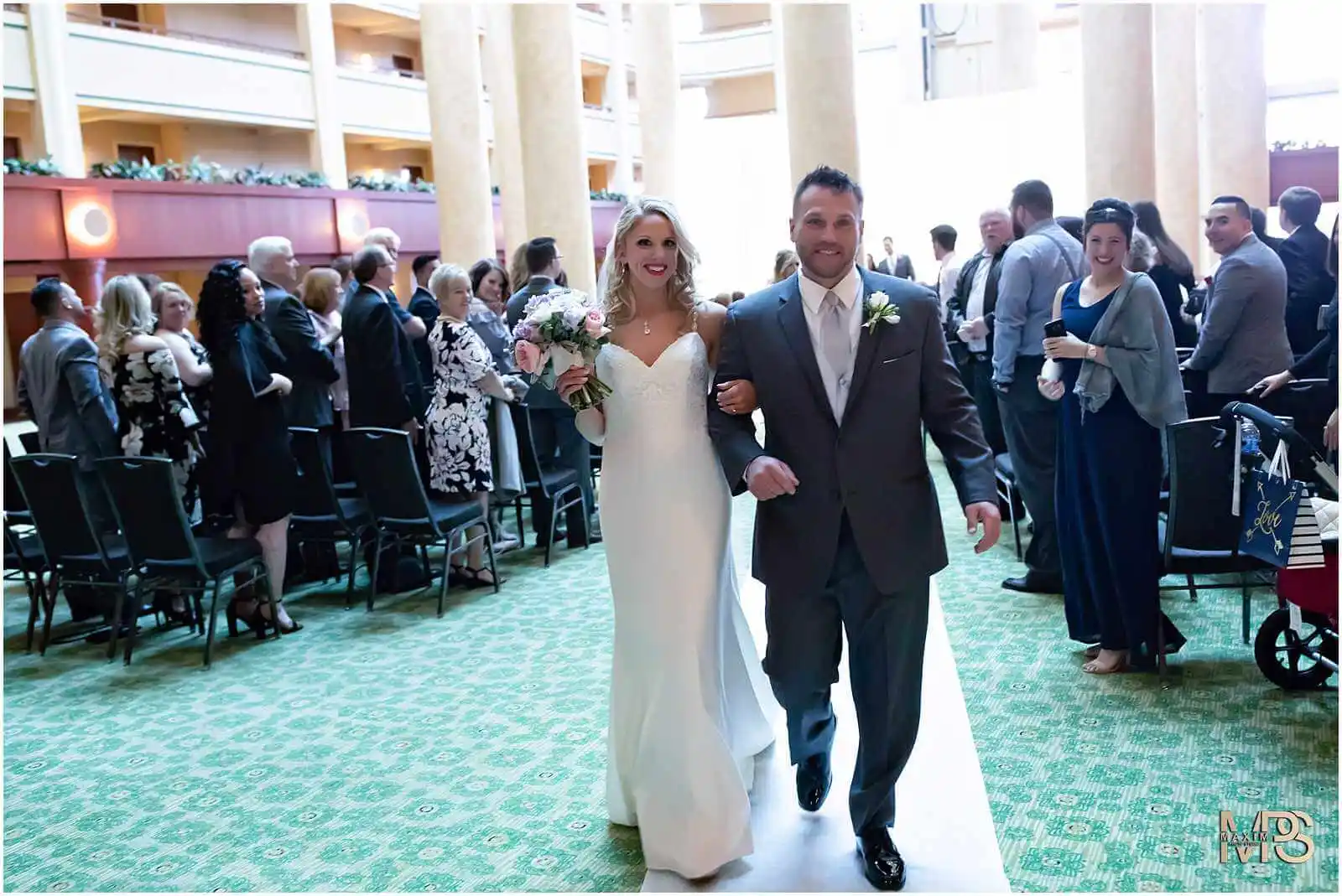 Radiant bride escorted by father on her wedding aisle walk Marriott Rivercenter Covington KY