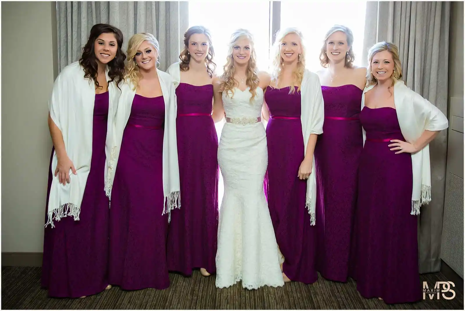 Bride and bridesmaids in elegant purple dresses at Covington KY wedding.