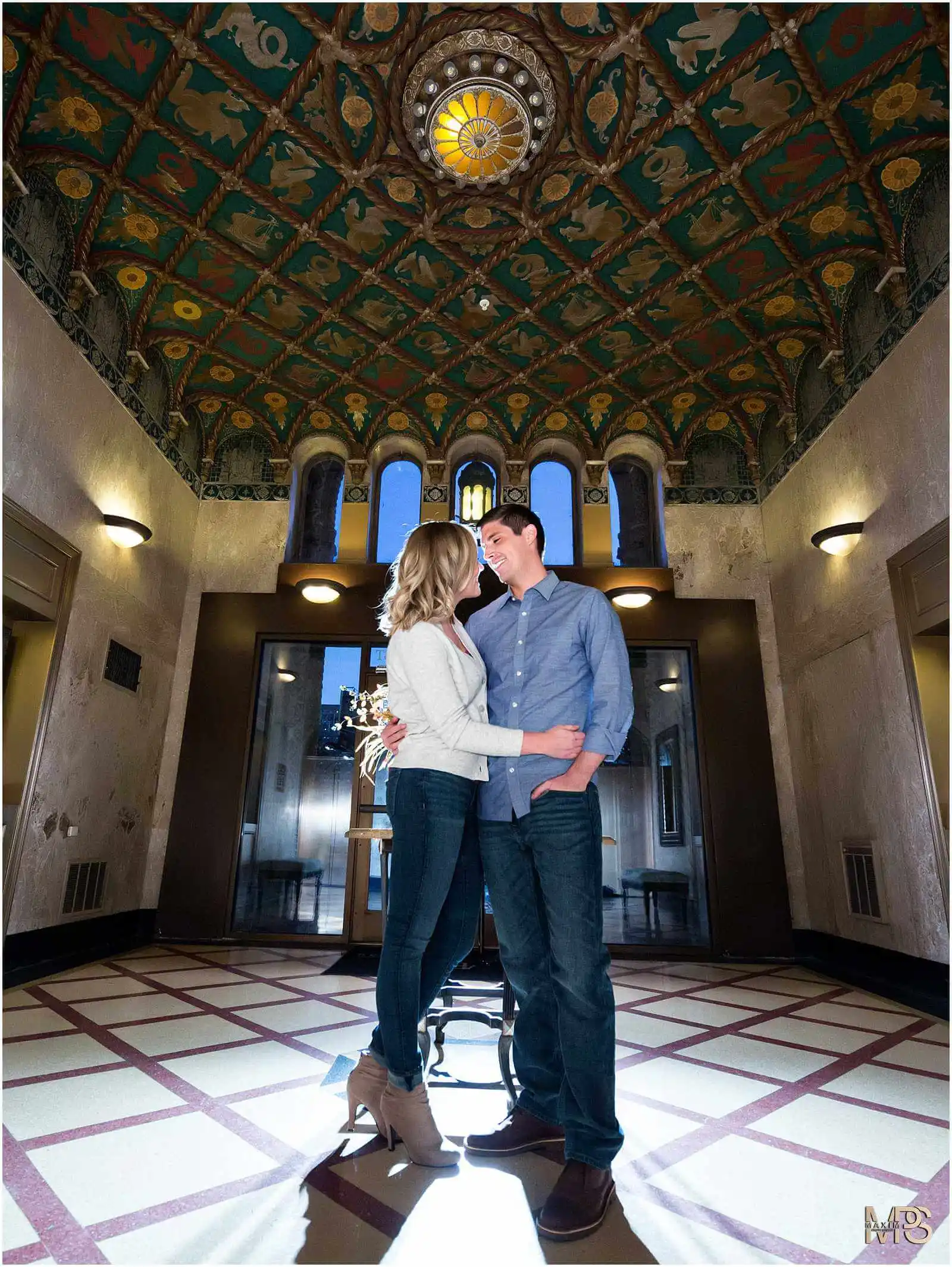 Loving couple embracing in a luxurious Art Deco interior.
