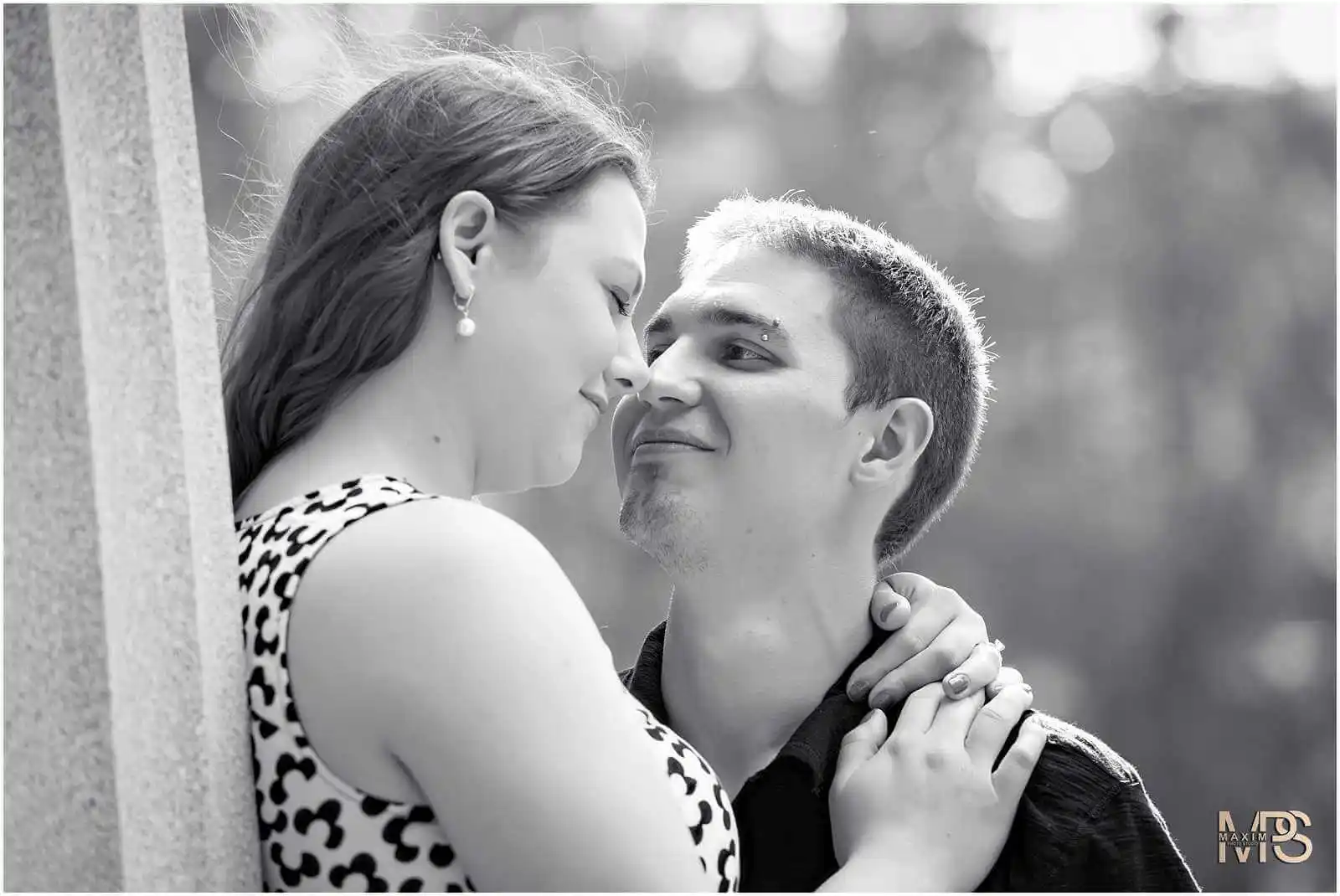 Romantic couple embracing in black and white portrait.