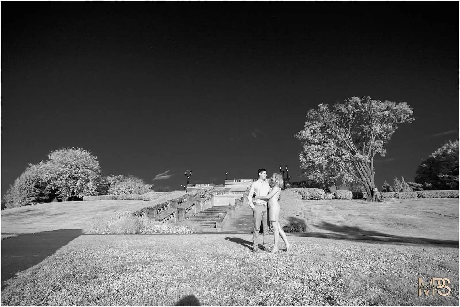 Couple posing in a park with infrared photography effect.