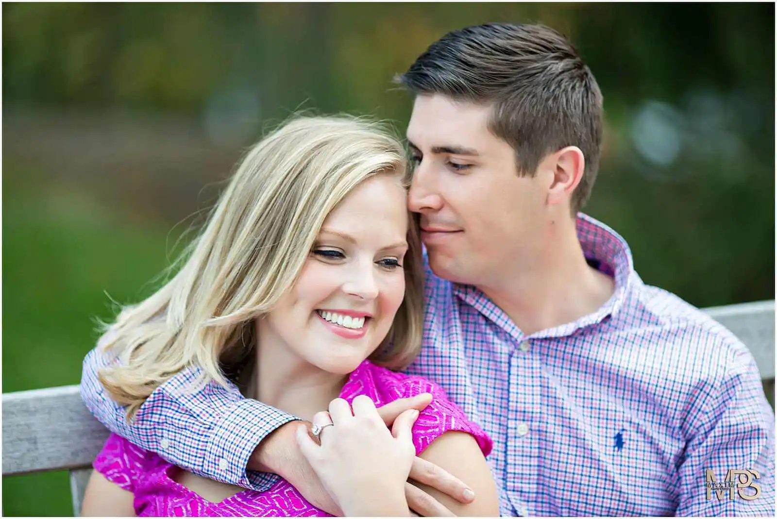 Smiling couple embracing in a romantic outdoor photoshoot.