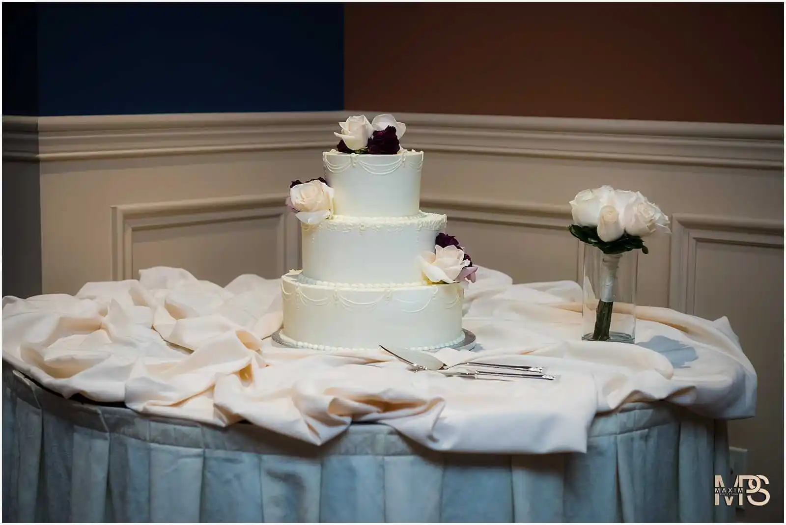 Sophisticated floral three-tier wedding cake at Covington venue.