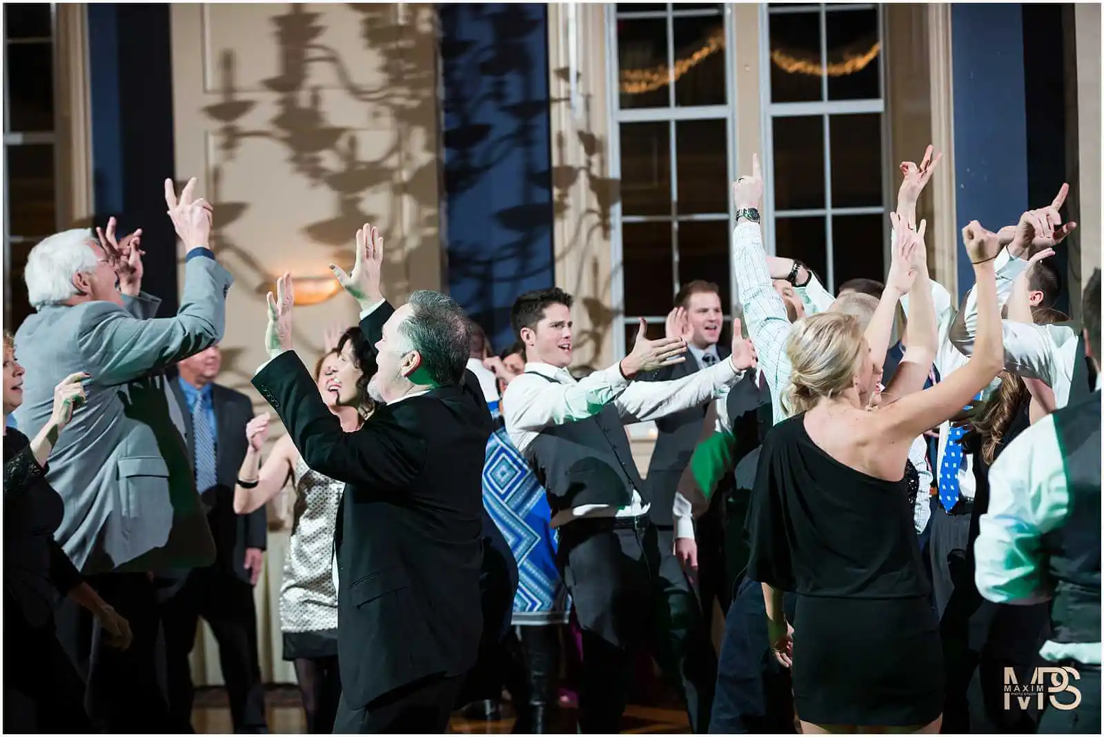 Joyful guests dancing at an evening celebration event at the Grand Ballroom