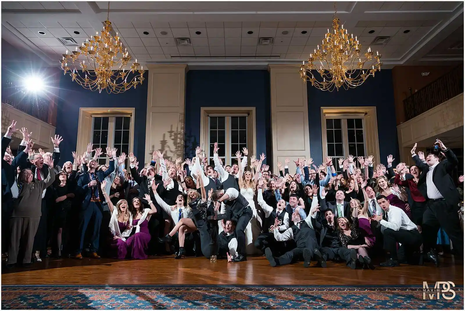 Joyful guests celebrating at an elegant event with raised hands The Grand Covington KY