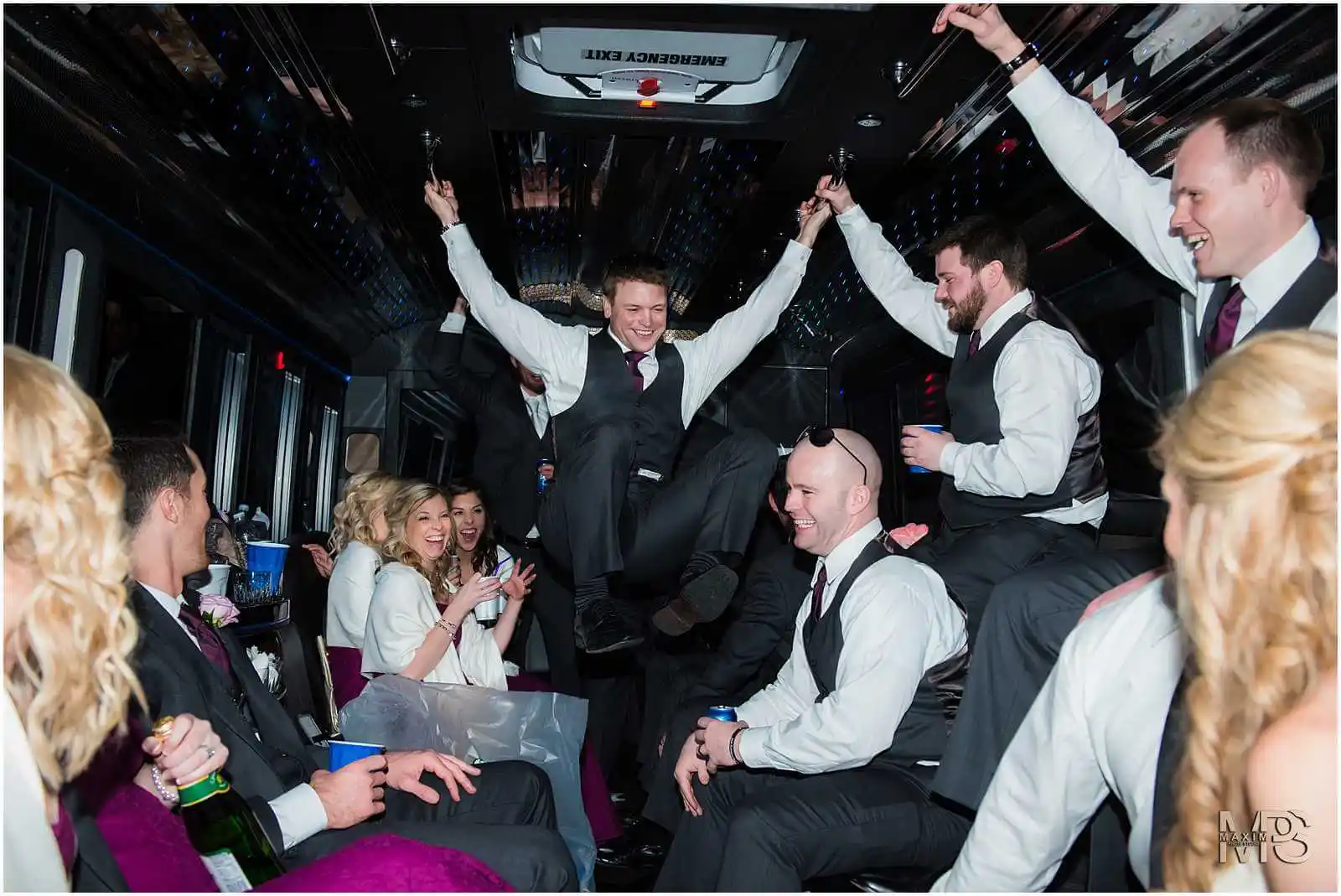 Energetic friends enjoying a lively party in a luxury bus.
