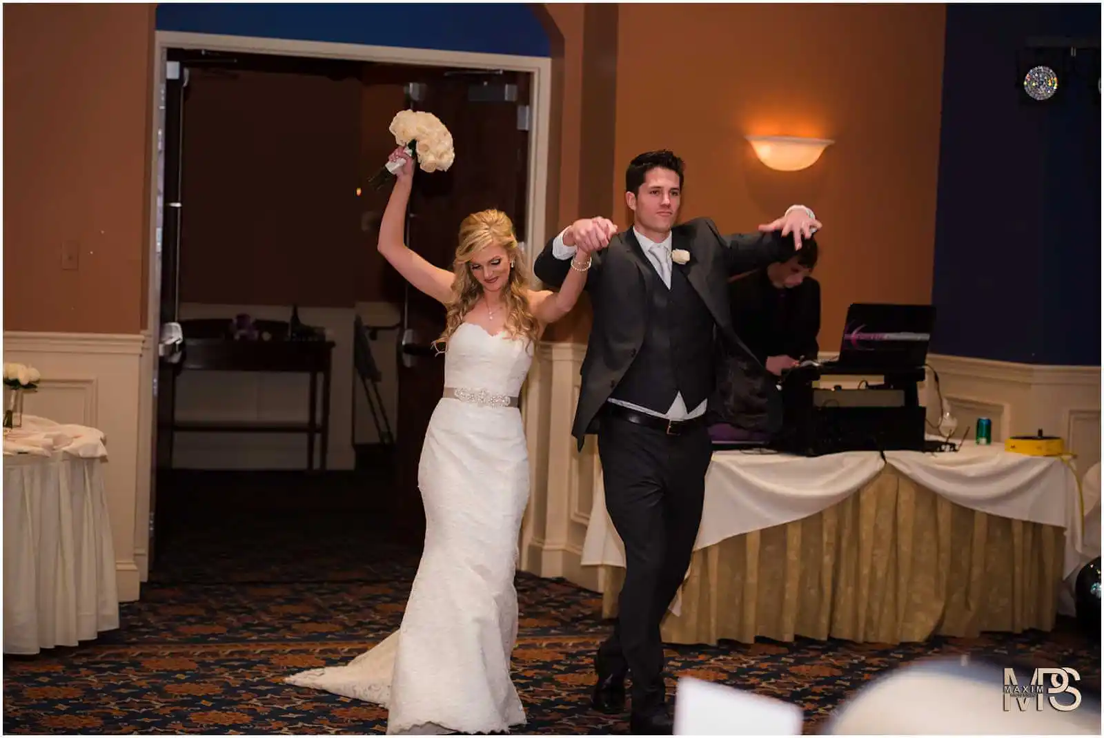 Joyful newlyweds dancing into their reception in Covington, KY.