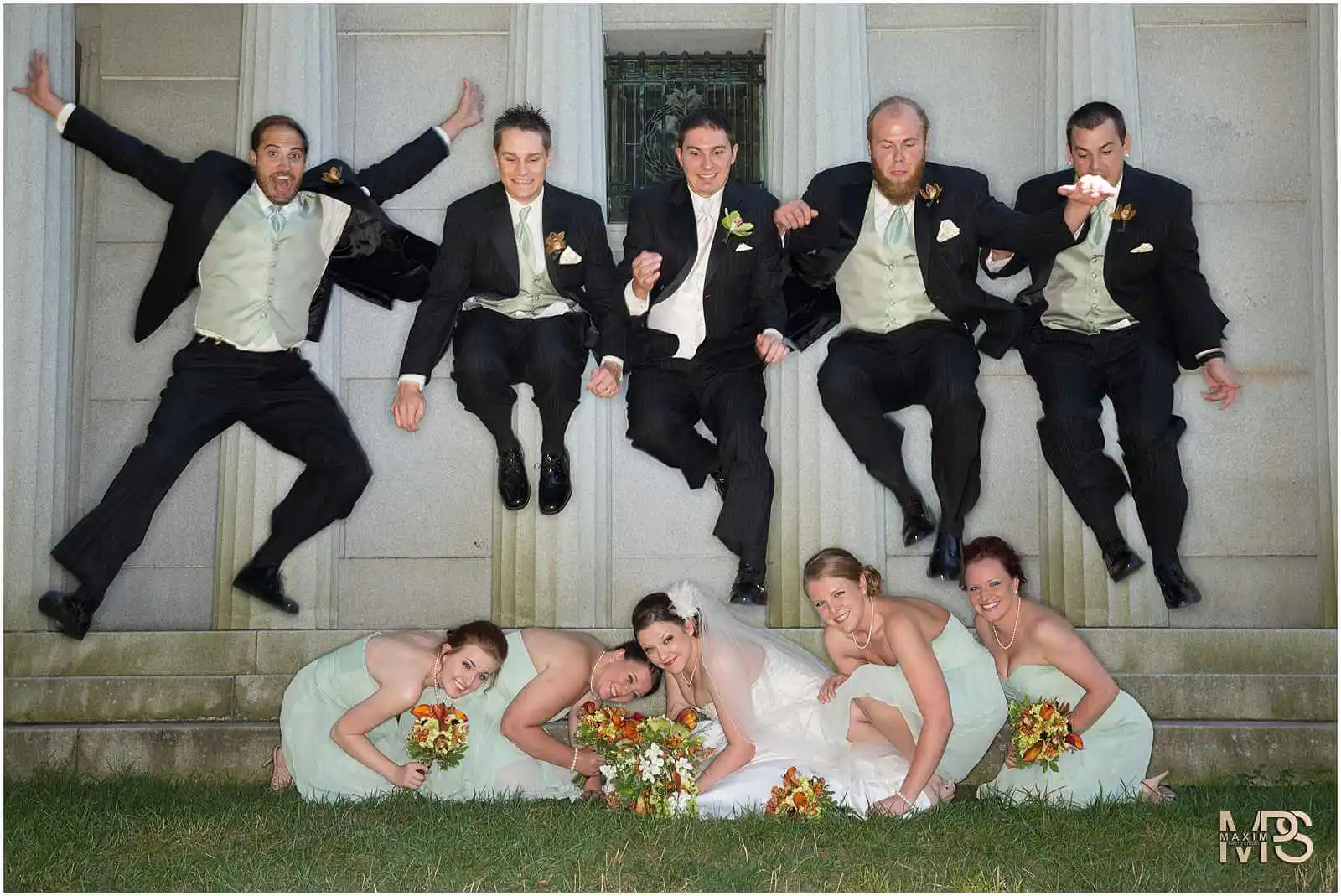 Joyful bridal party posing for creative wedding photo.