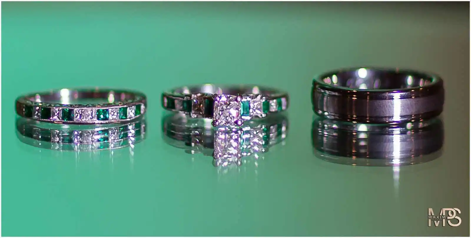 Elegant diamond wedding ring set on a green background.