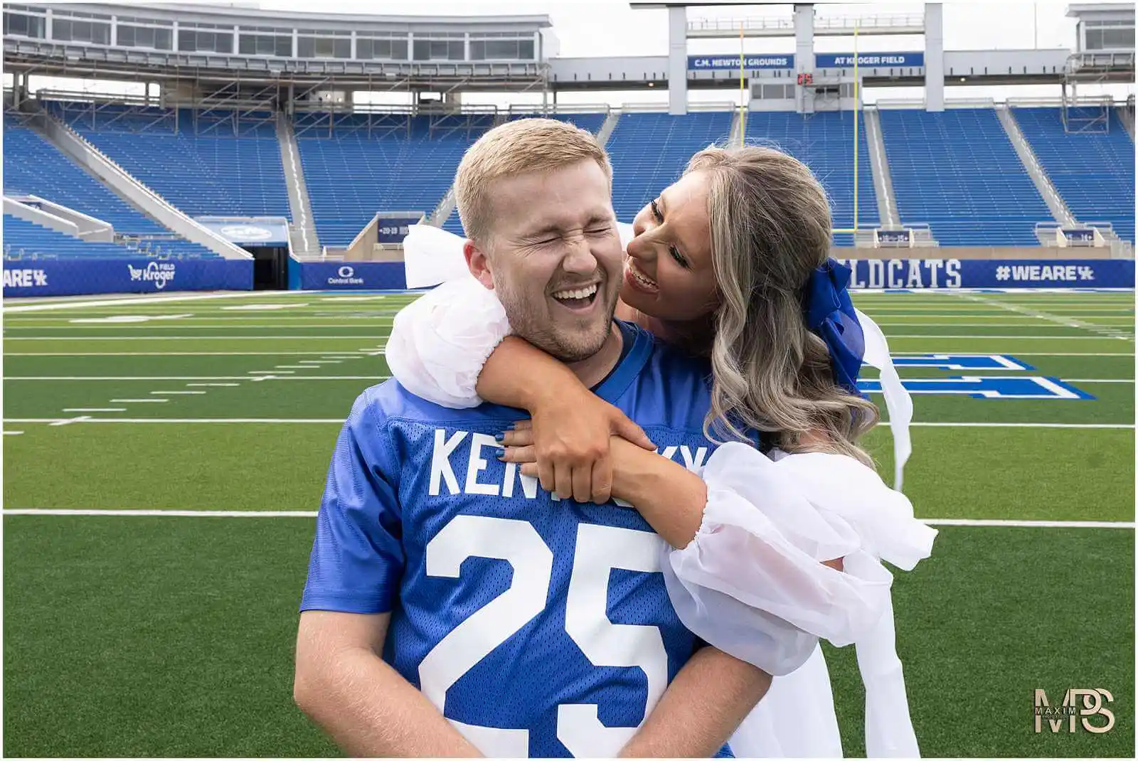 Bride and Groom whispering at UK Kroger Field engagement photography session