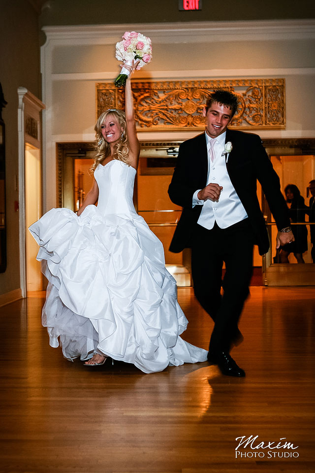 bride and groom enter the music hall reception