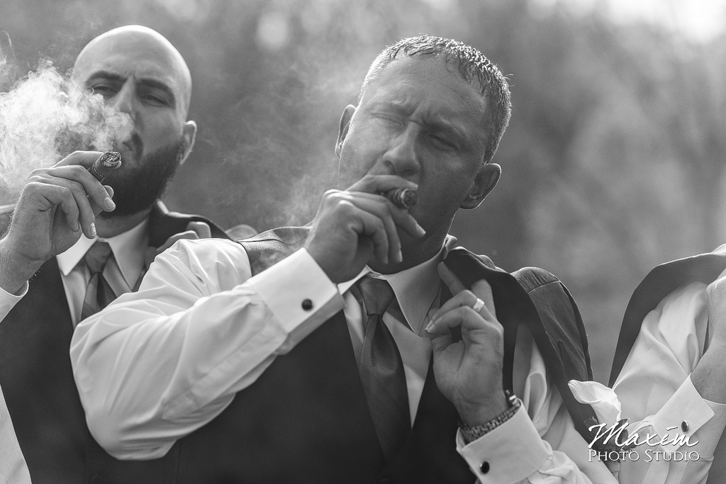 Groom smoking a wedding day cigar Glenwood Gardens