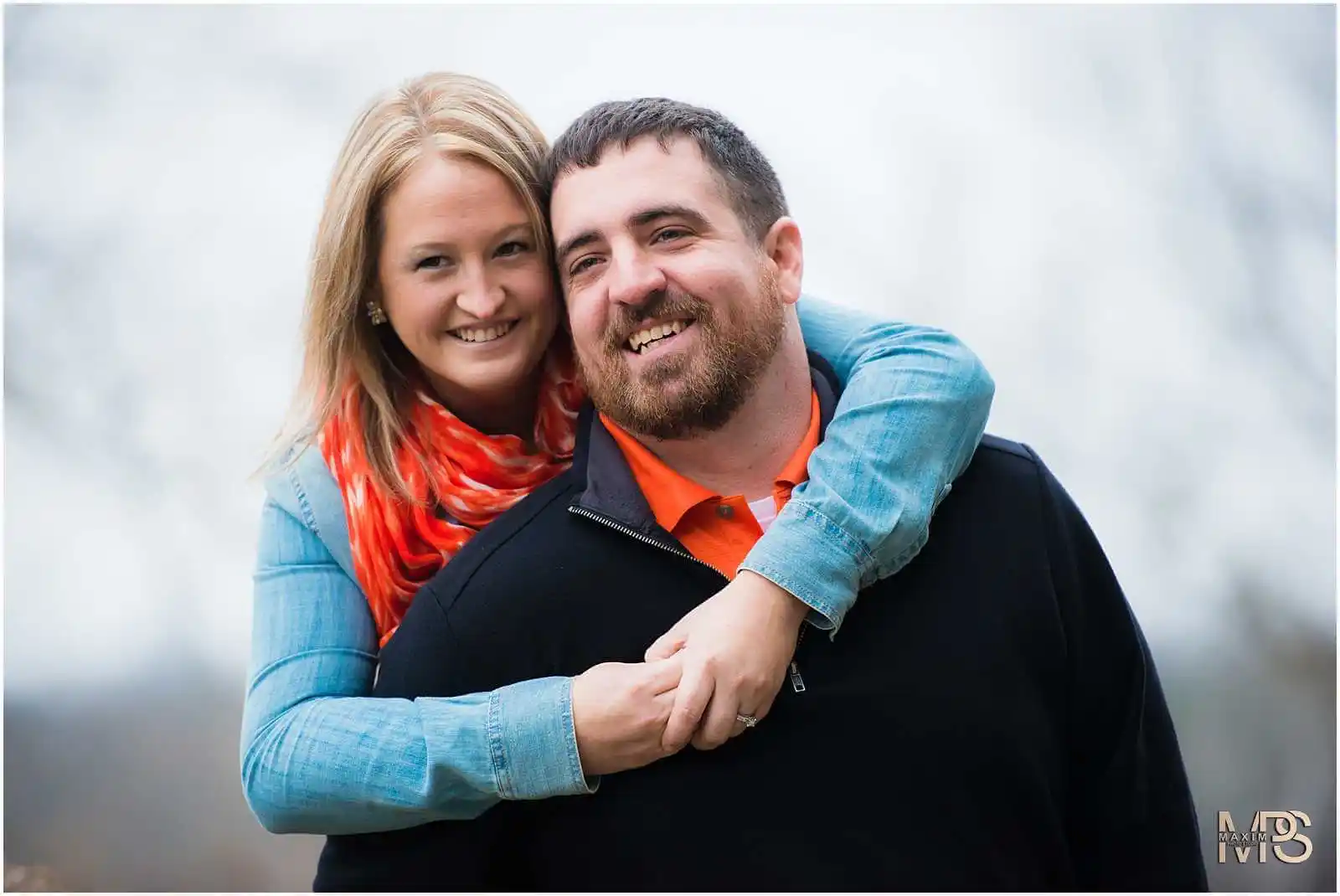 a man and woman smiling at Glenwood Gardens in Cincinnati engagement