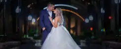 Bride and groom embrace at illuminated Cincinnati Club fall wedding.
